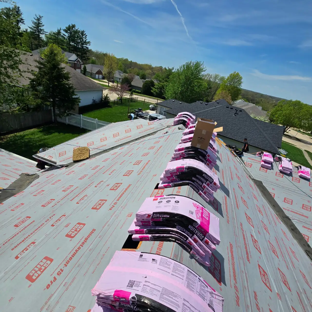 JBS Roofers crew installing new underlayment during a roof replacement